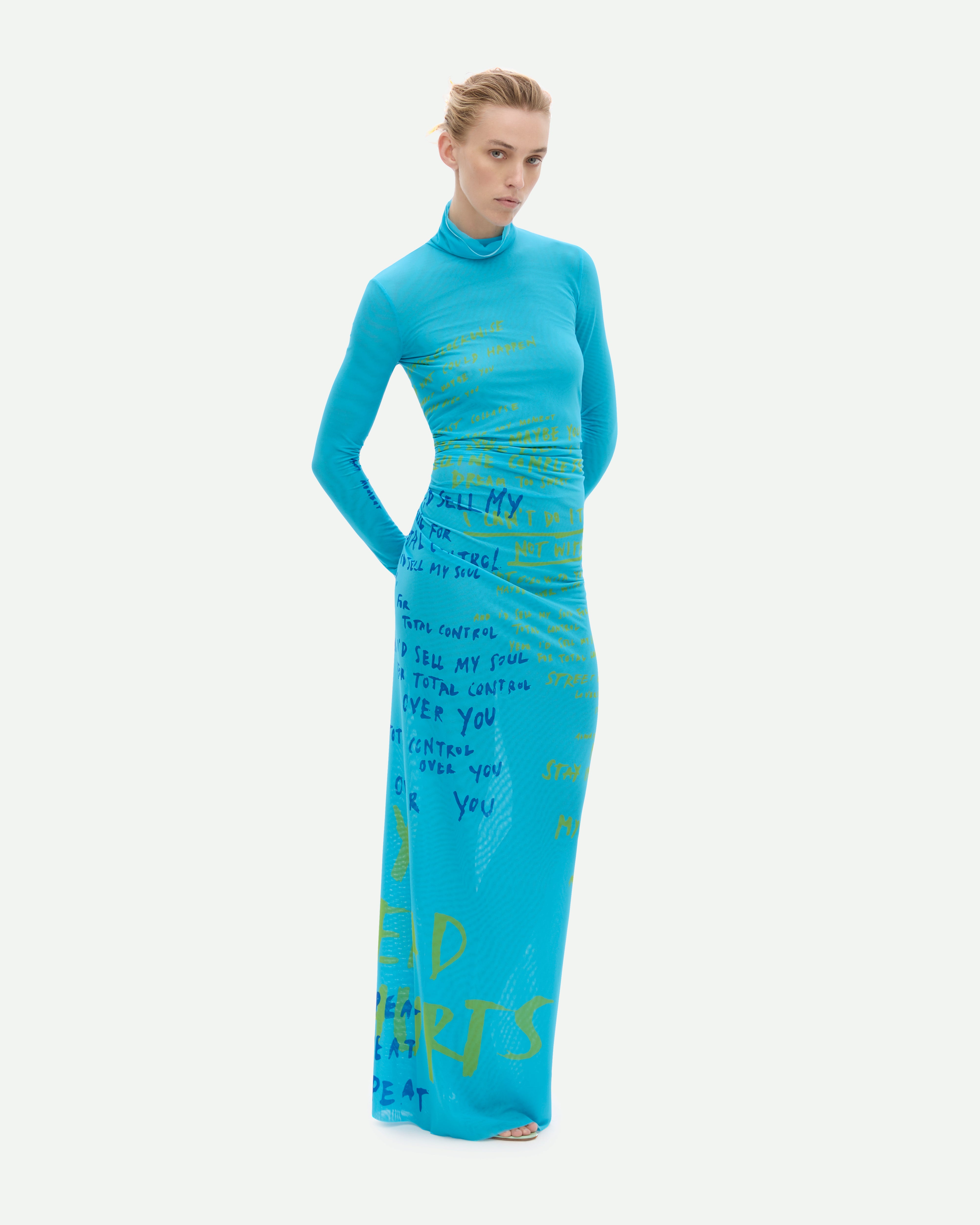 A long turquoise mesh dress with a placement print, featuring a high neck and long sleeves.