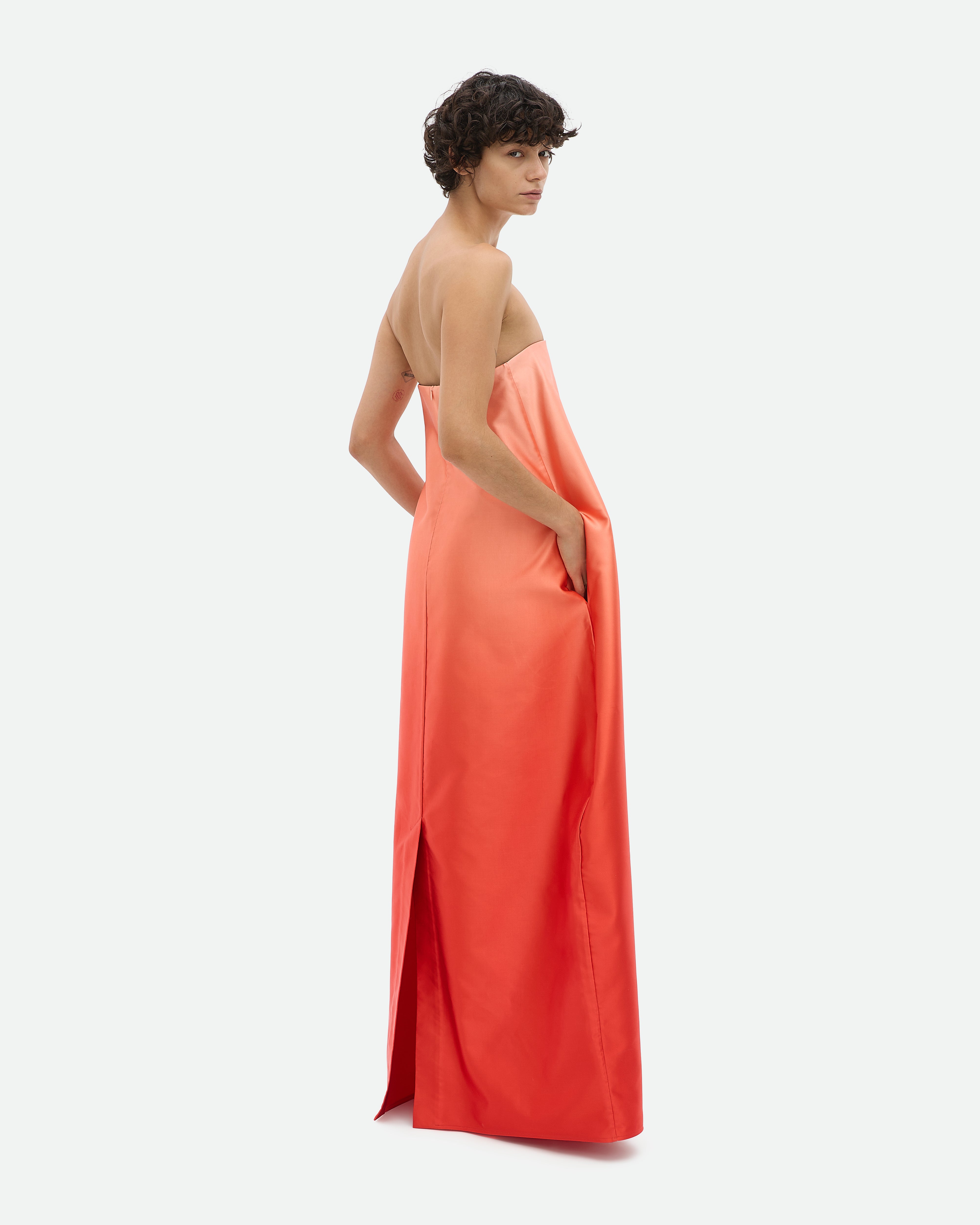 Woman wearing a summer orange maxi dress Entourage by Common Hours.