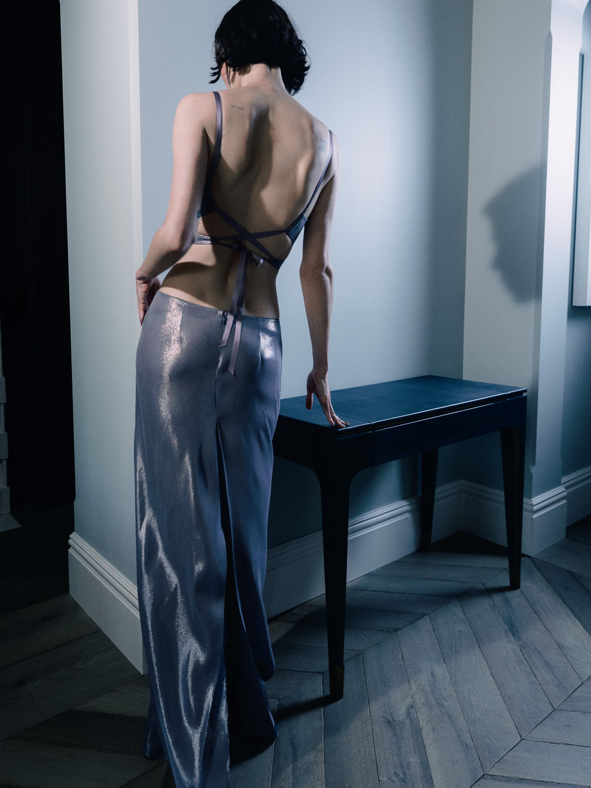 Model wearing Common Hours x Abbey Lee Euphoria long skirt with low waist in vesper grey lurex