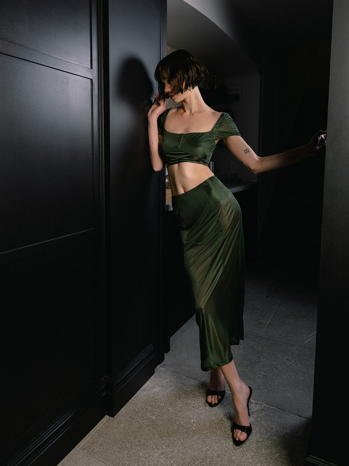 The Unfolding skirt in green Emerald is lingerie-inspired, in semi-sheer stretch jersey from Common Hours x Abbey Lee collection.