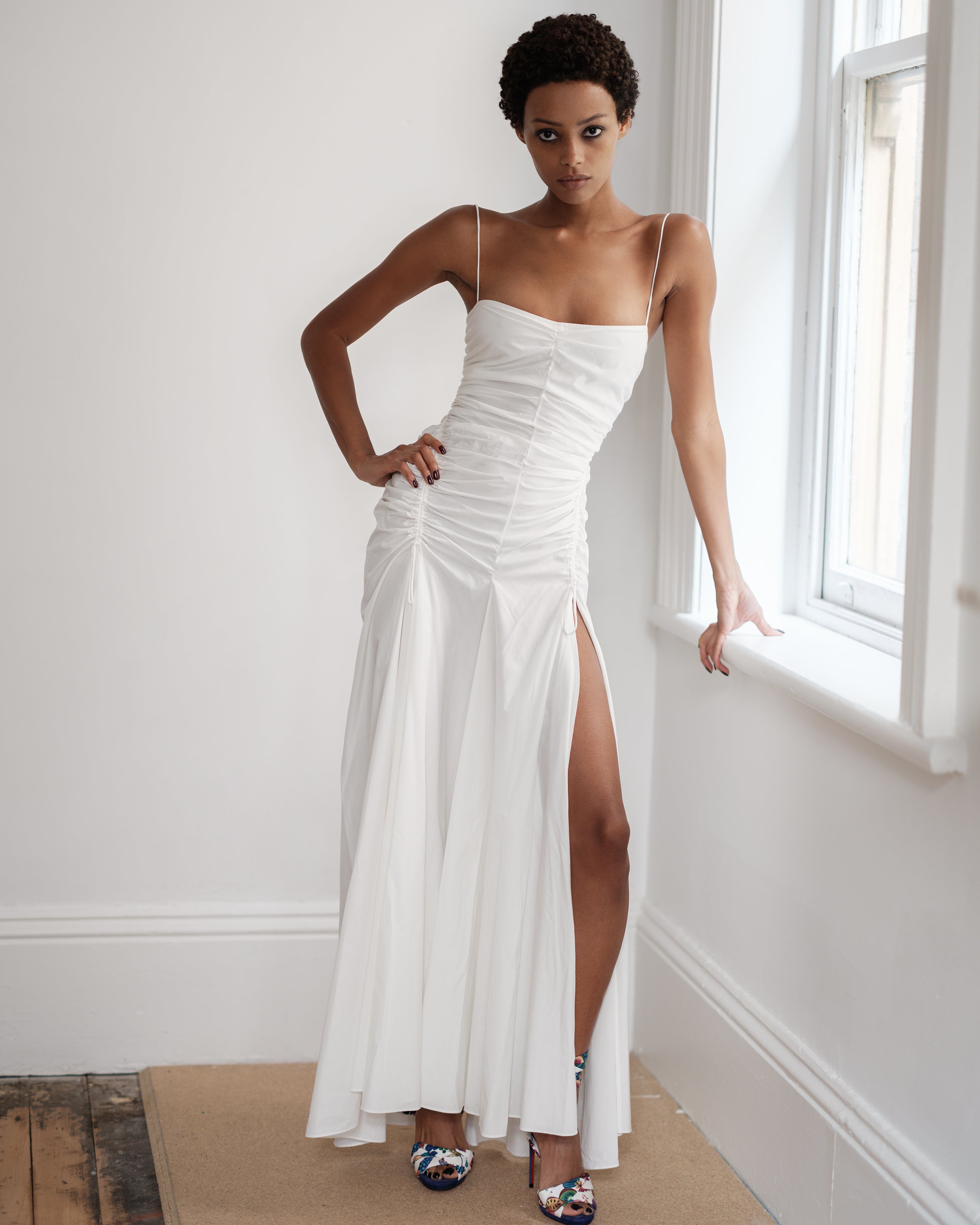 Woman wearing a white summer dress Three Points of Majesty by Common Hours.