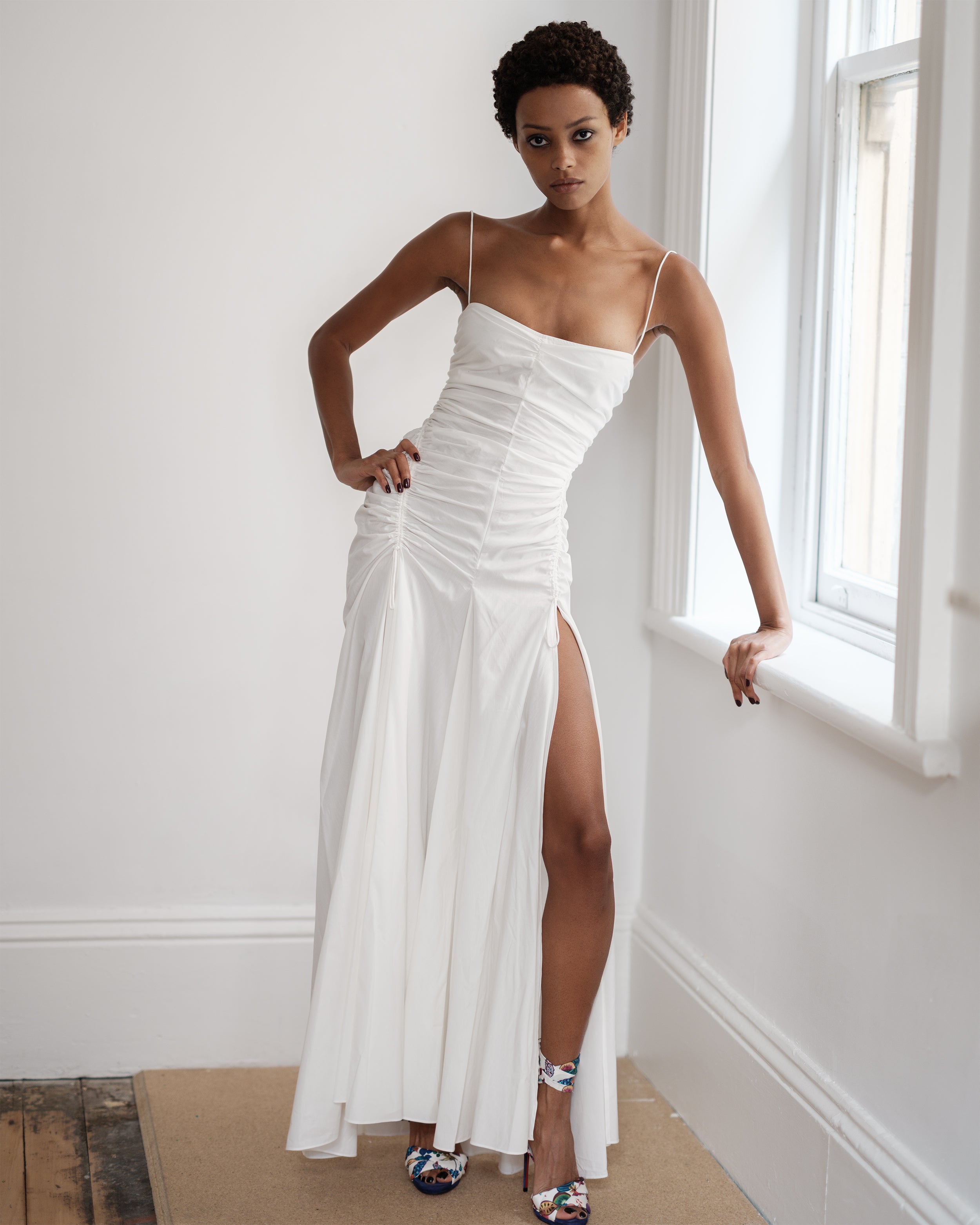 Woman wearing a white summer dress Three Points of Majesty by Common Hours.