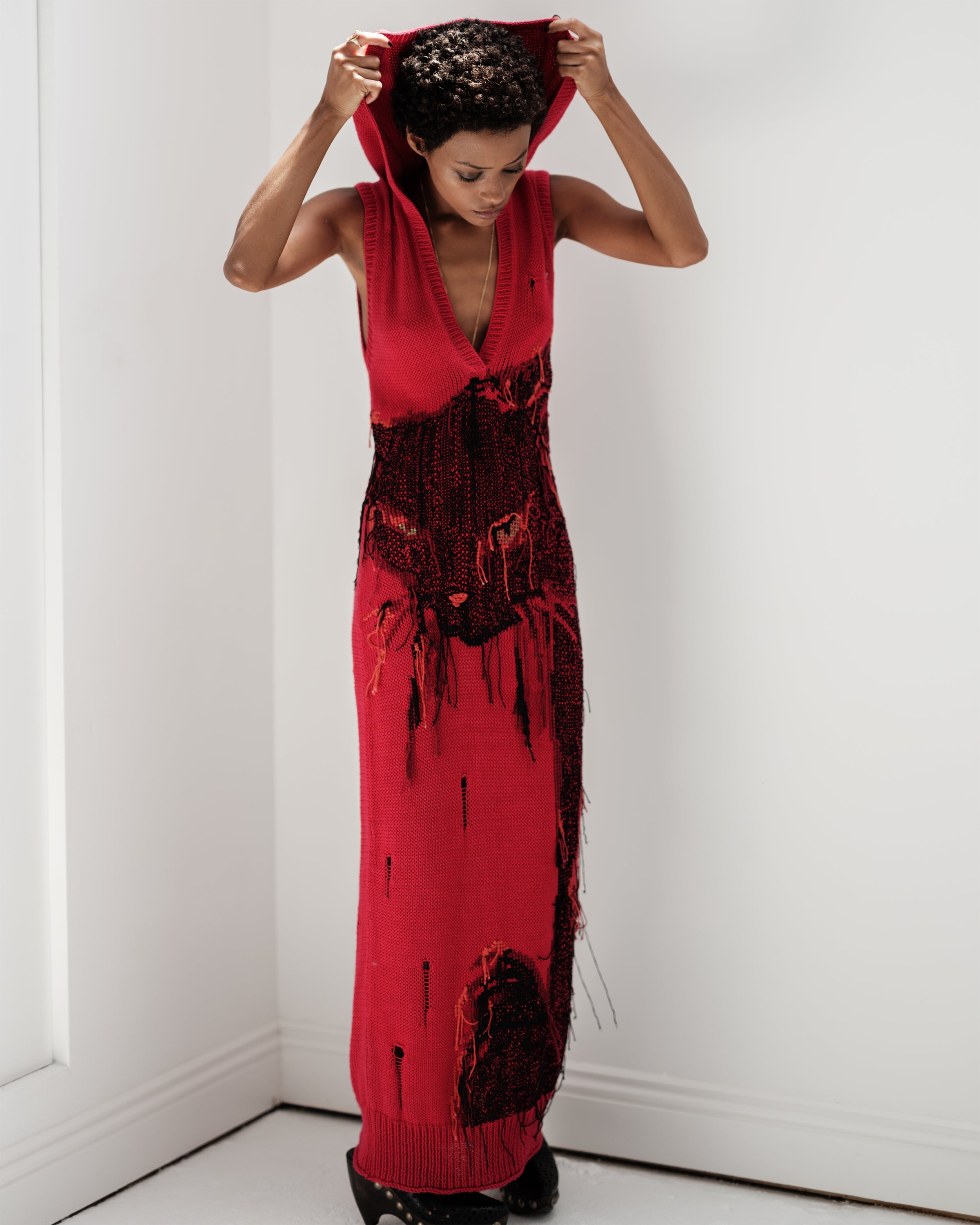 Vicious Common Hours knit red dress with black pattern and hoodie.