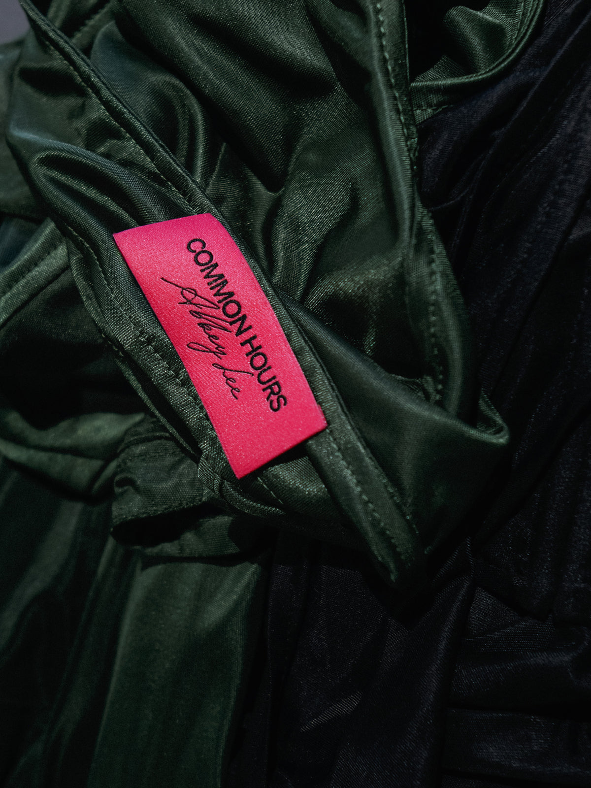 Common Hours x Abbey Lee collection label in pink