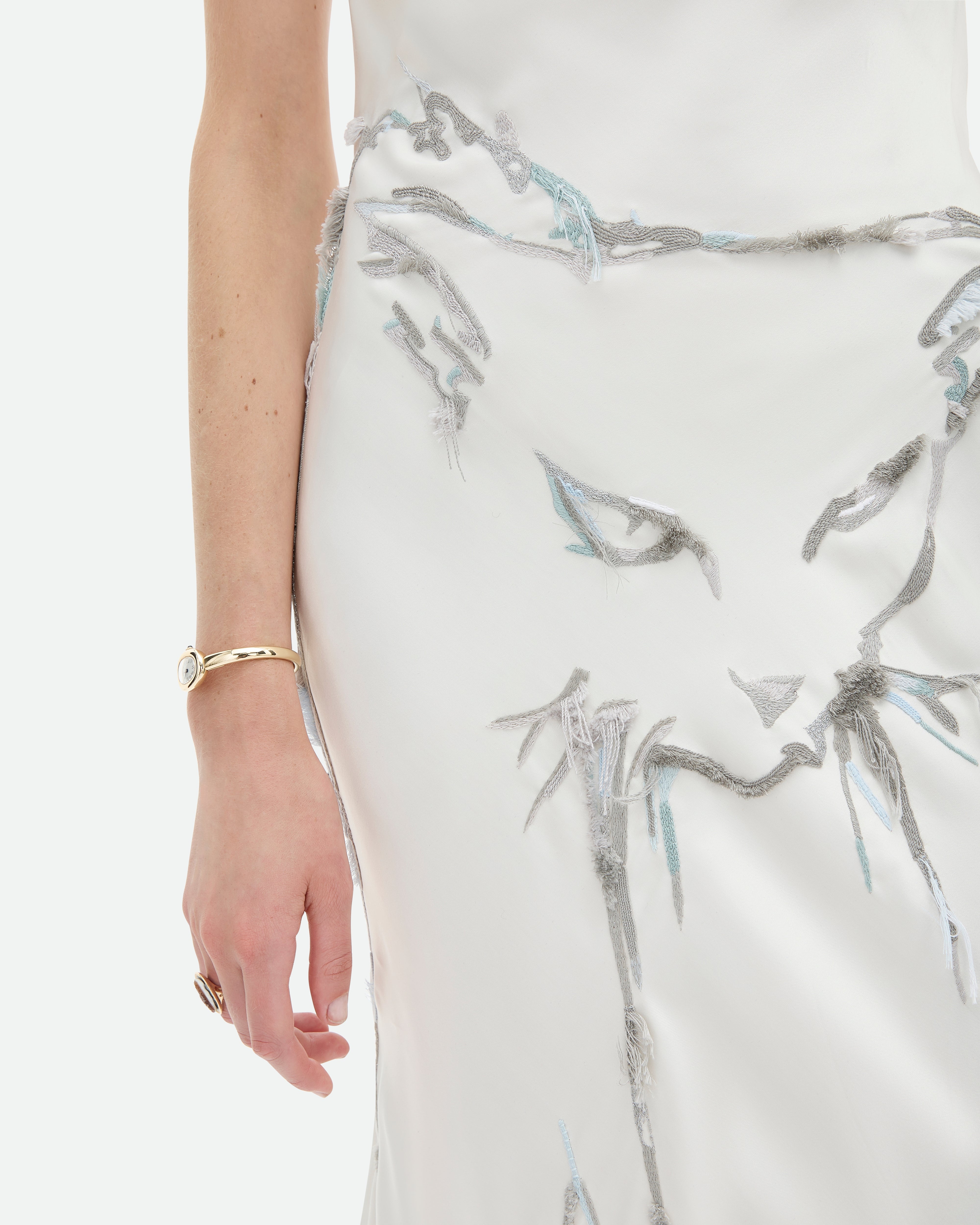 Rapture from Common Hours is a white, cowl neck, bias cut gown with cat hand-embroidery.