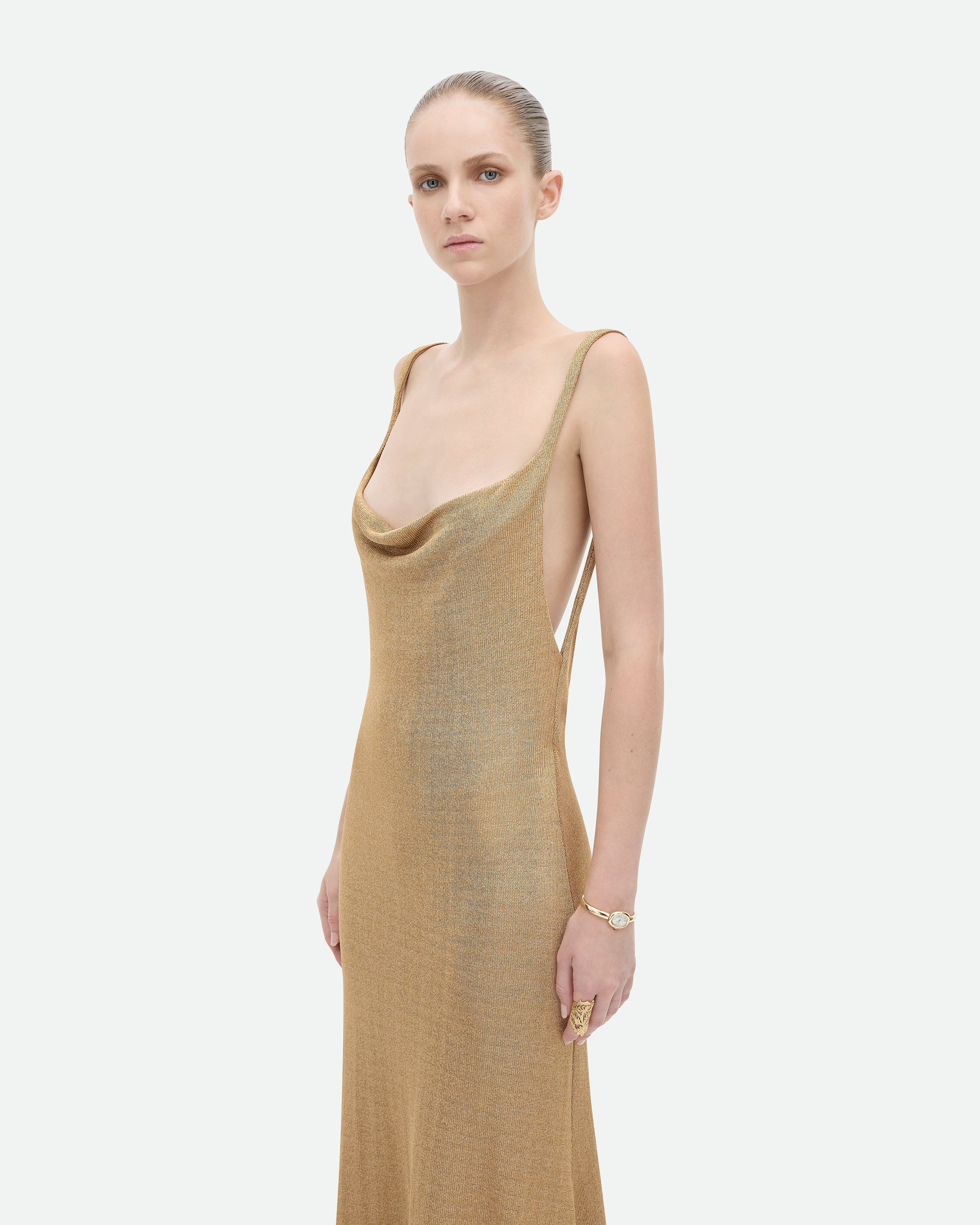 Long, flowing gold metallic dress with open back, Common Hours Prohibition dress.