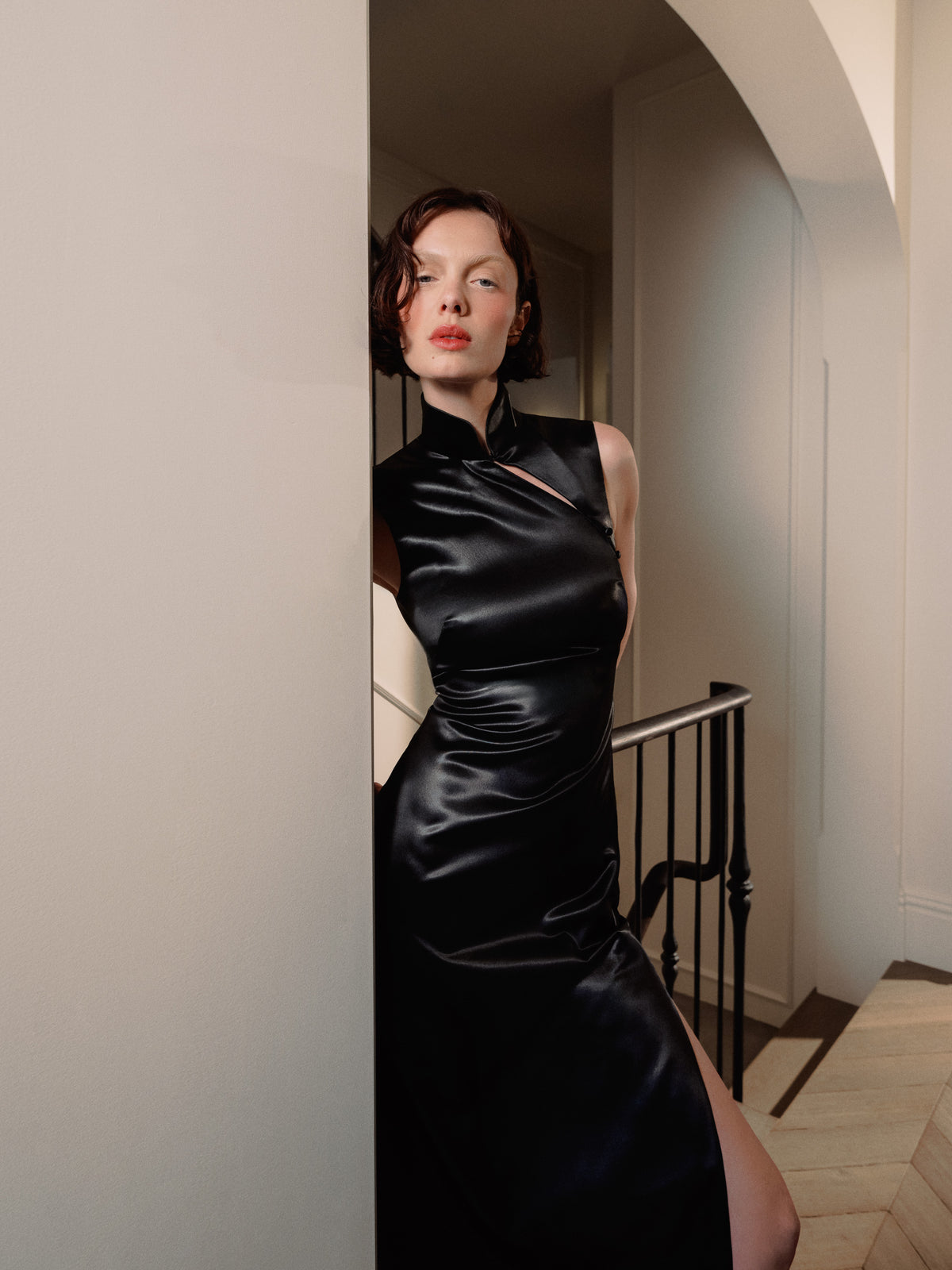 Hyper-feminine Devotion dress from Common Hours x Abbey Lee collection, in black satin inspired by Wong Kar-wai's film In the Mood for Love.
