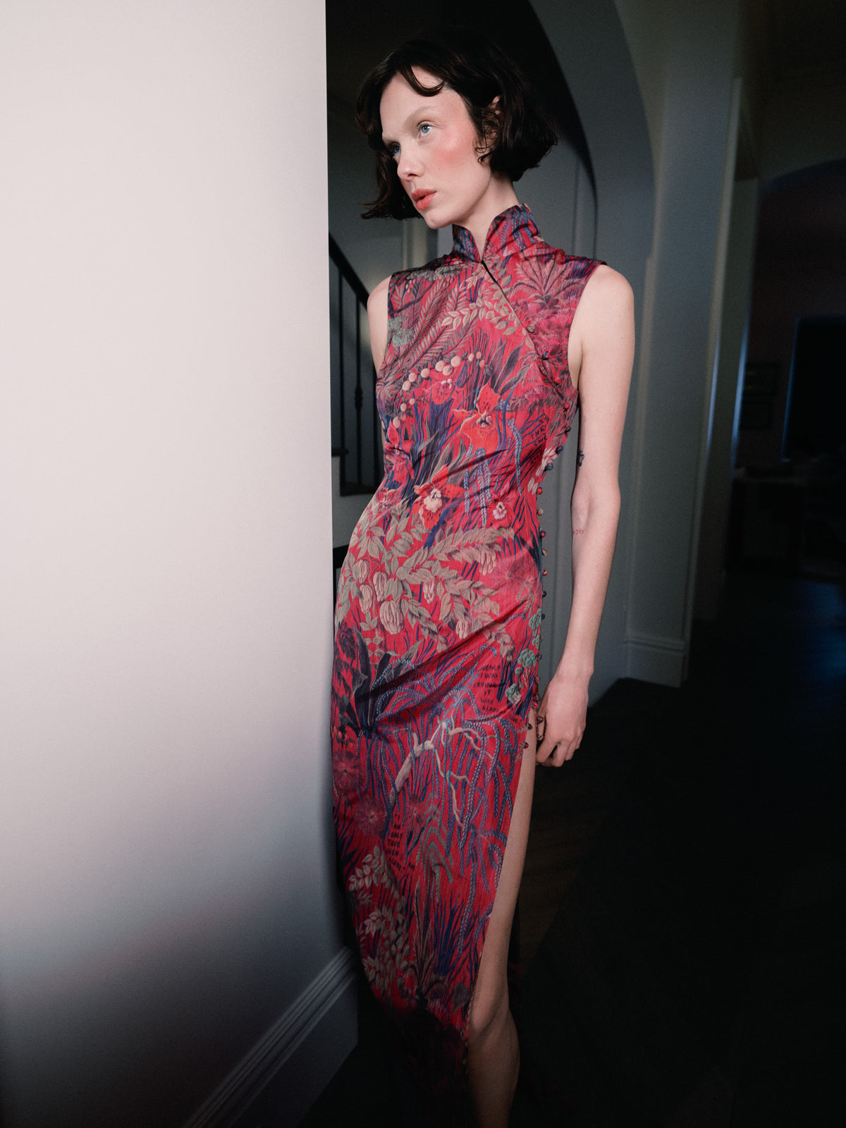 Hyper-feminine Devotion dress from Common Hours x Abbey Lee collection, in Pink Wallpaper Floral, with a floor-length body-wrap effect. 