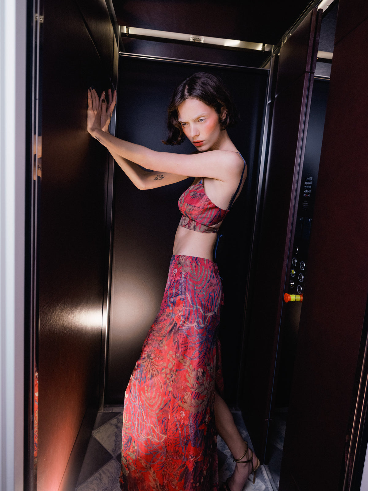 Model wearing Common Hours x Abbey Lee Euphoria Skirt in pink Wallpaper Floral