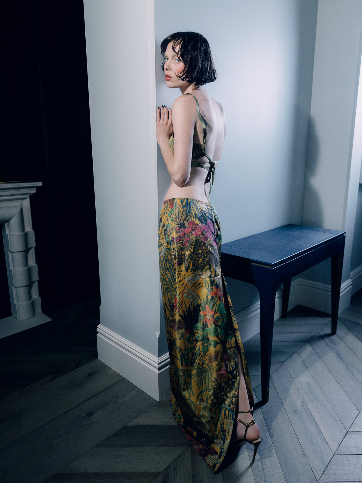 Model wearing Common Hours and Abbey Lee Euphoria crop bustier top in Yellow Wallpaper Floral