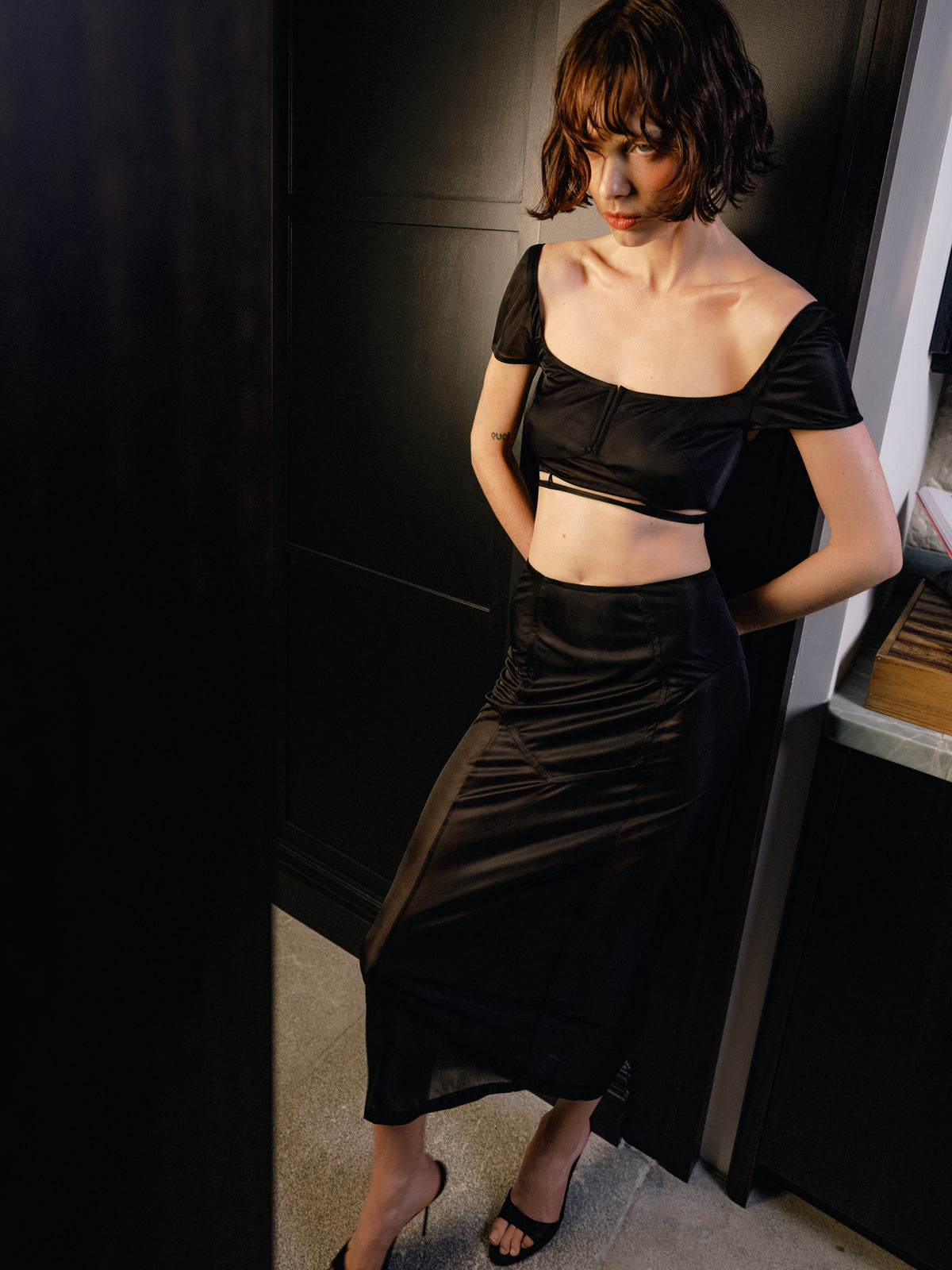 The Unfolding wrap bra top from Common Hours x Abbey Lee collection in semi-sheer Emerald black stretch jersey.