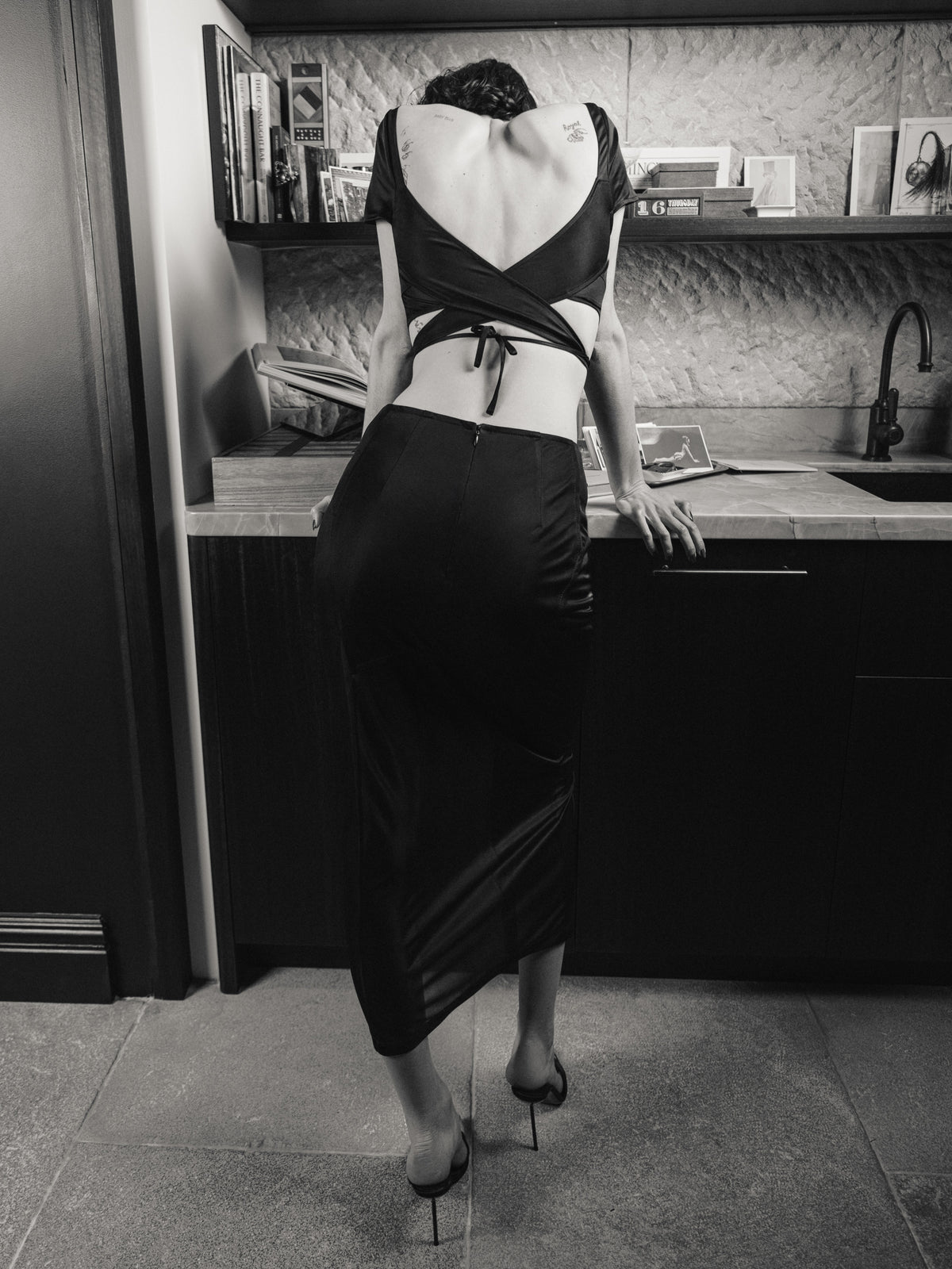 The Unfolding skirt from the back, in black semi-sheer stretch jersey from Common Hours x Abbey Lee collection.