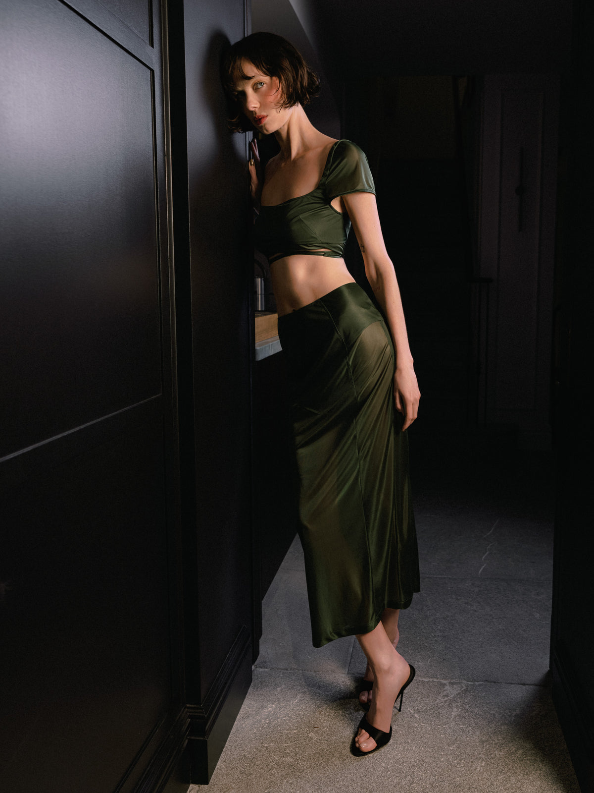 The Unfolding wrap cropped top from Common Hours x Abbey Lee collection is lingerie-inspired bra top in semi-sheer green stretch jersey.